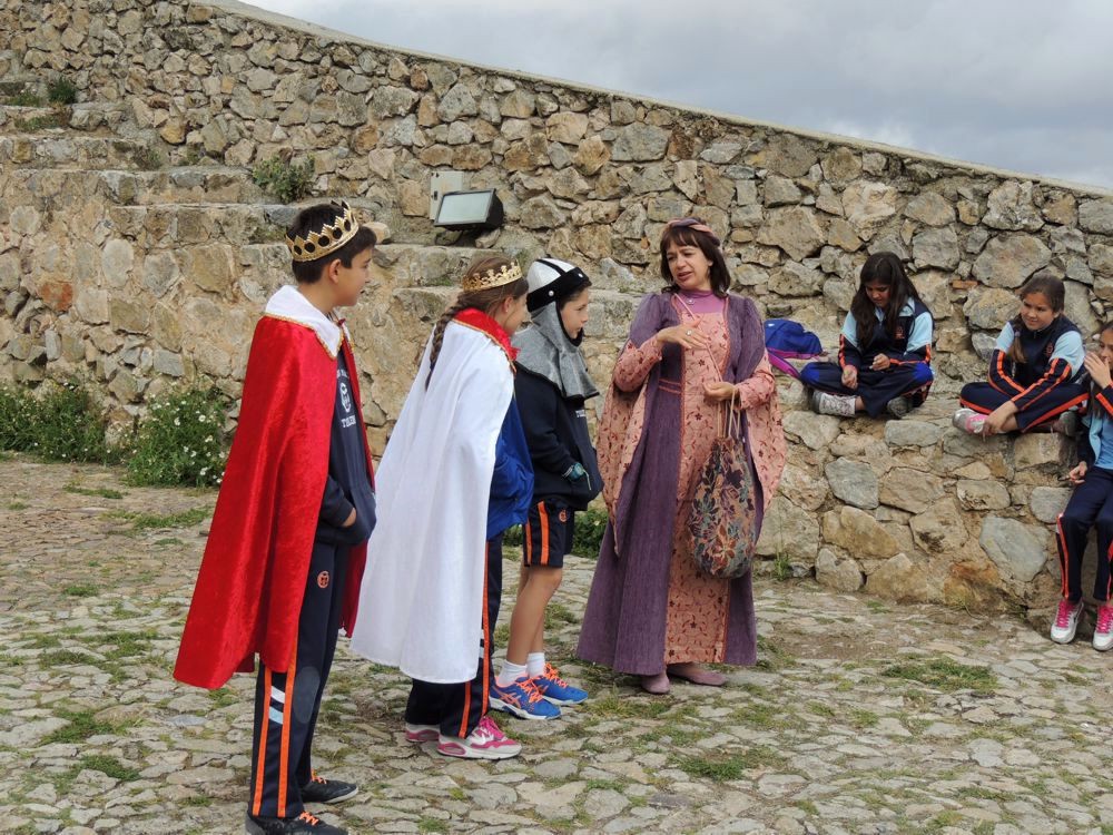 School group play acting on outdoor terrace